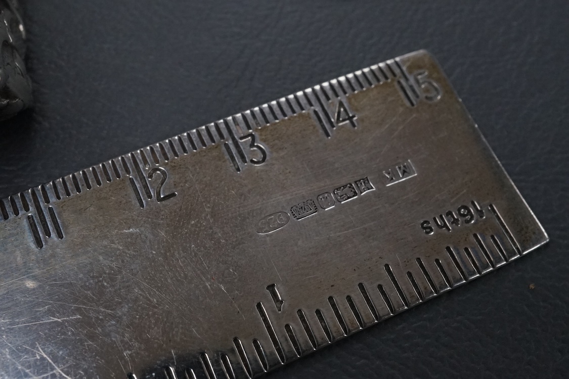 A small group of collectable silver including a Dutch miniature silver cradle box, import marks for London, 1898, 53mm, two other white metal miniature items including a chair, a continental 930 white metal taste vin, a